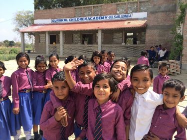 Kinderen in paarse schooluniformen voor hun school in India.